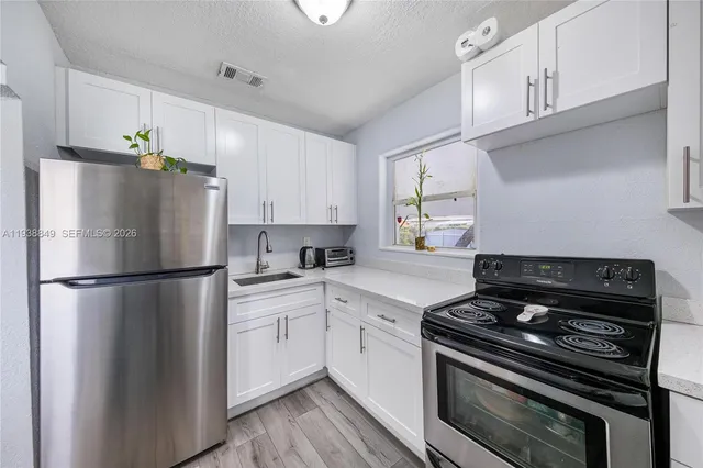 a white refrigerator freezer sitting inside of a kitchen