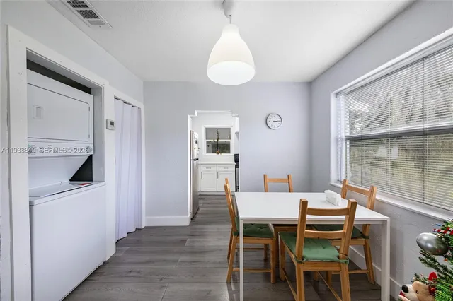 a dining room with furniture and window