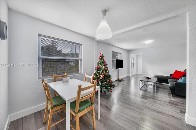 a view of a dining room with furniture window and wooden floor