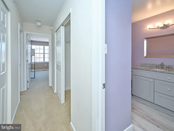 a view of a hallway with bathroom and bathroom