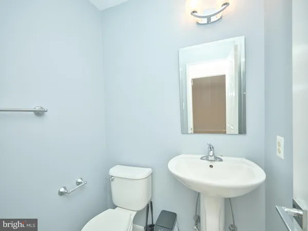 a bathroom with a sink a mirror and a toilet