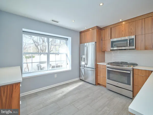 a kitchen with stainless steel appliances a stove sink and microwave