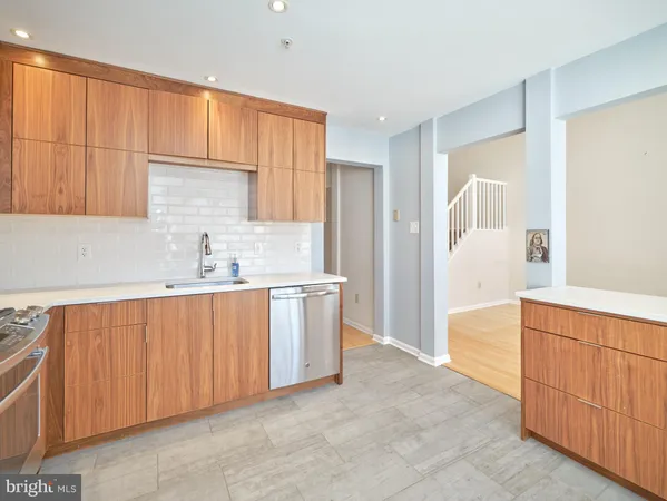 a kitchen with stainless steel appliances a sink stove and cabinets