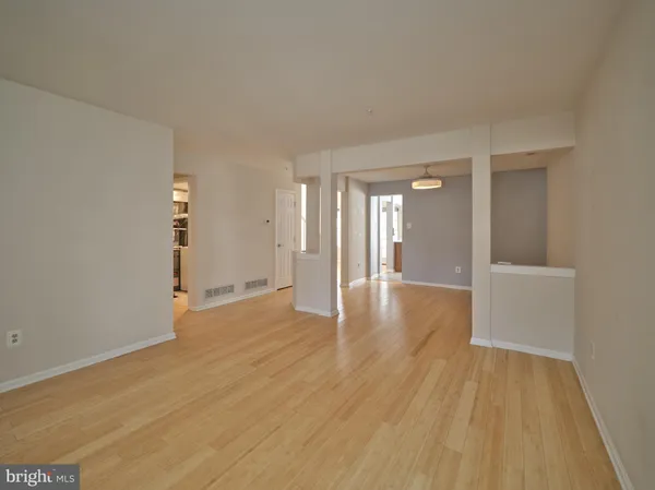 a view of an empty room and wooden floor