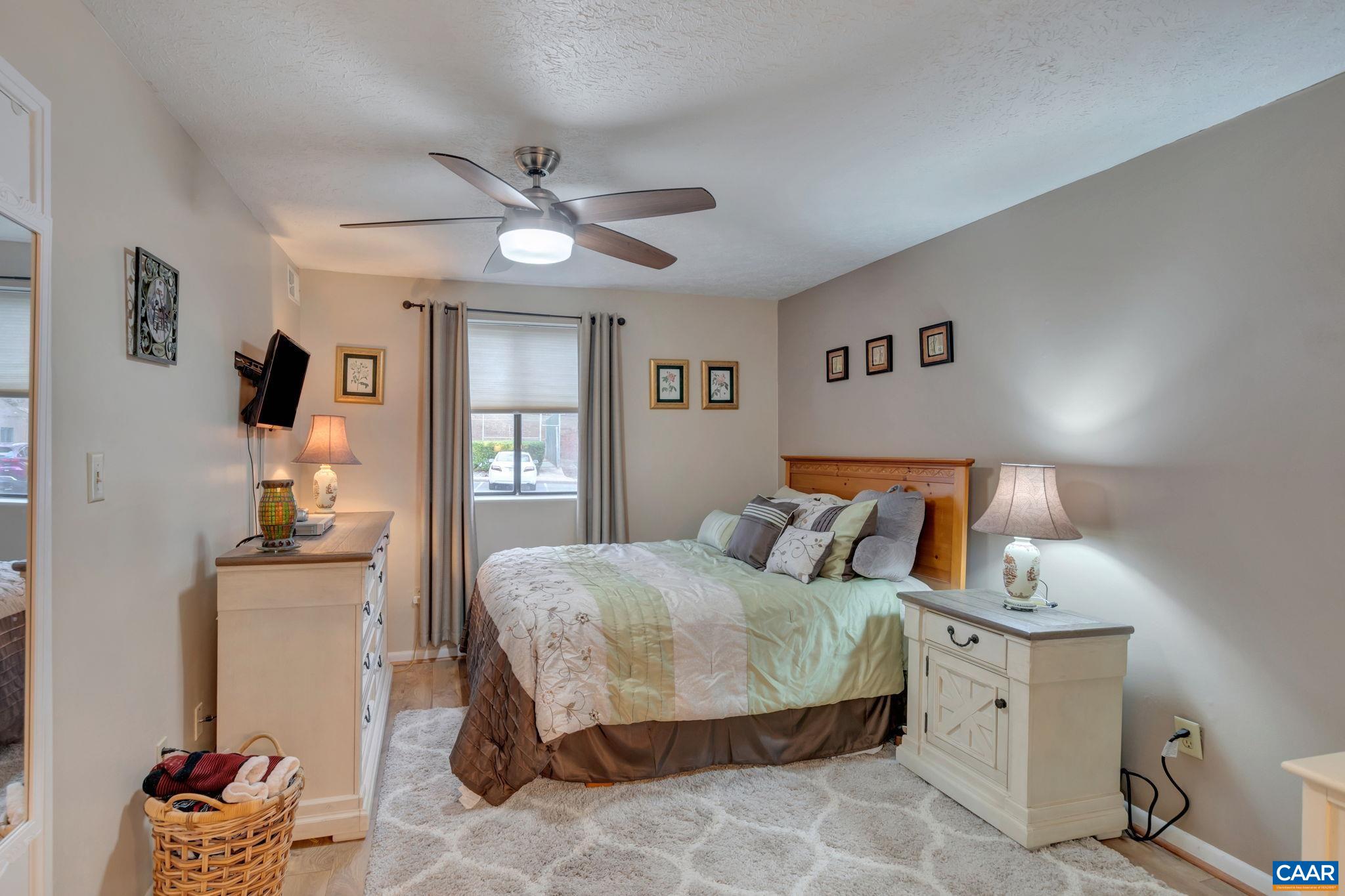 114 Turtle Creek Road, Unit 1 Charlottesville, VA 22901 - Photo 12 of 24 a bedroom with a bed and wooden floor