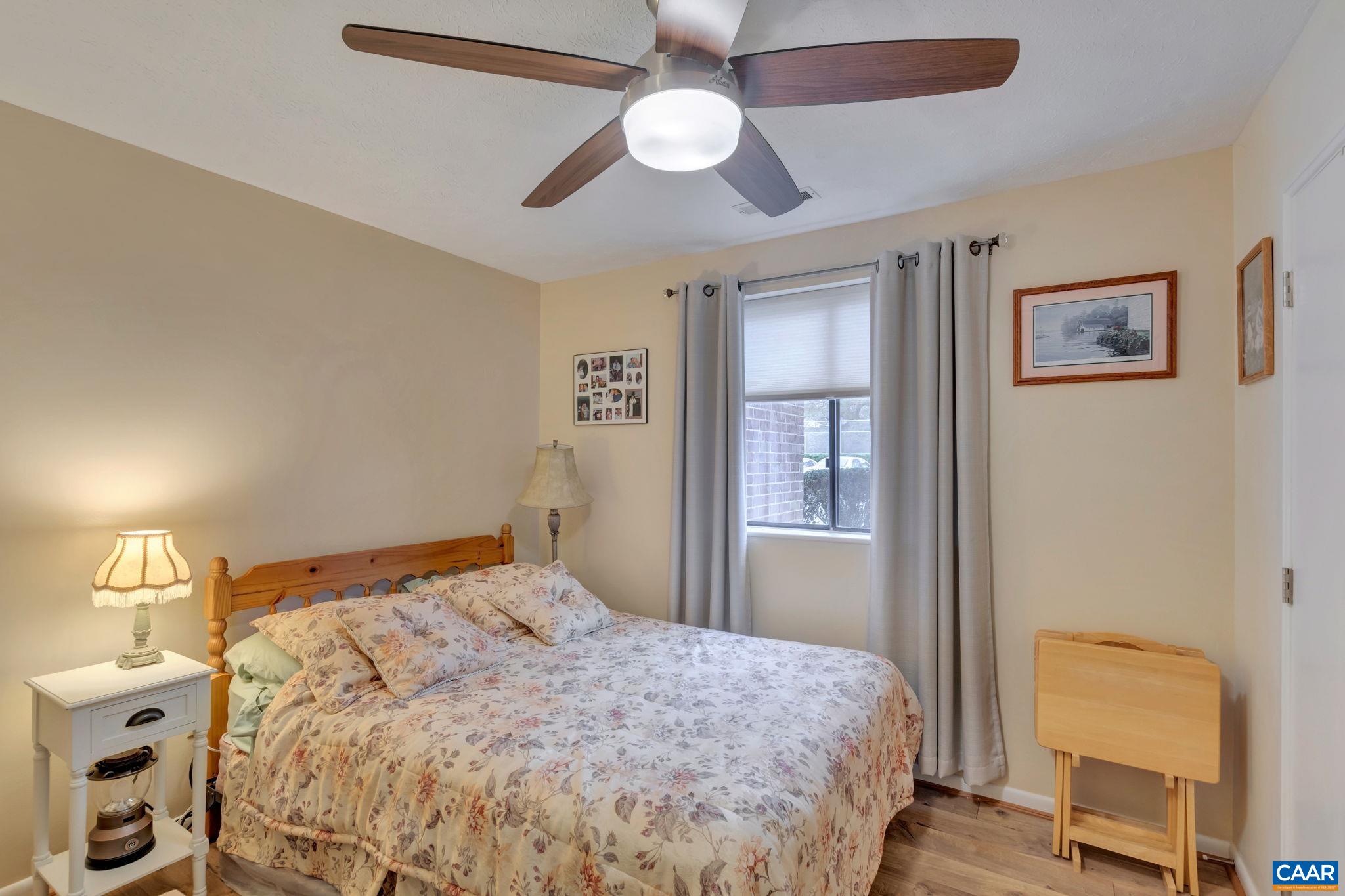 114 Turtle Creek Road, Unit 1 Charlottesville, VA 22901 - Photo 15 of 24 a bedroom with a bed and a chandelier