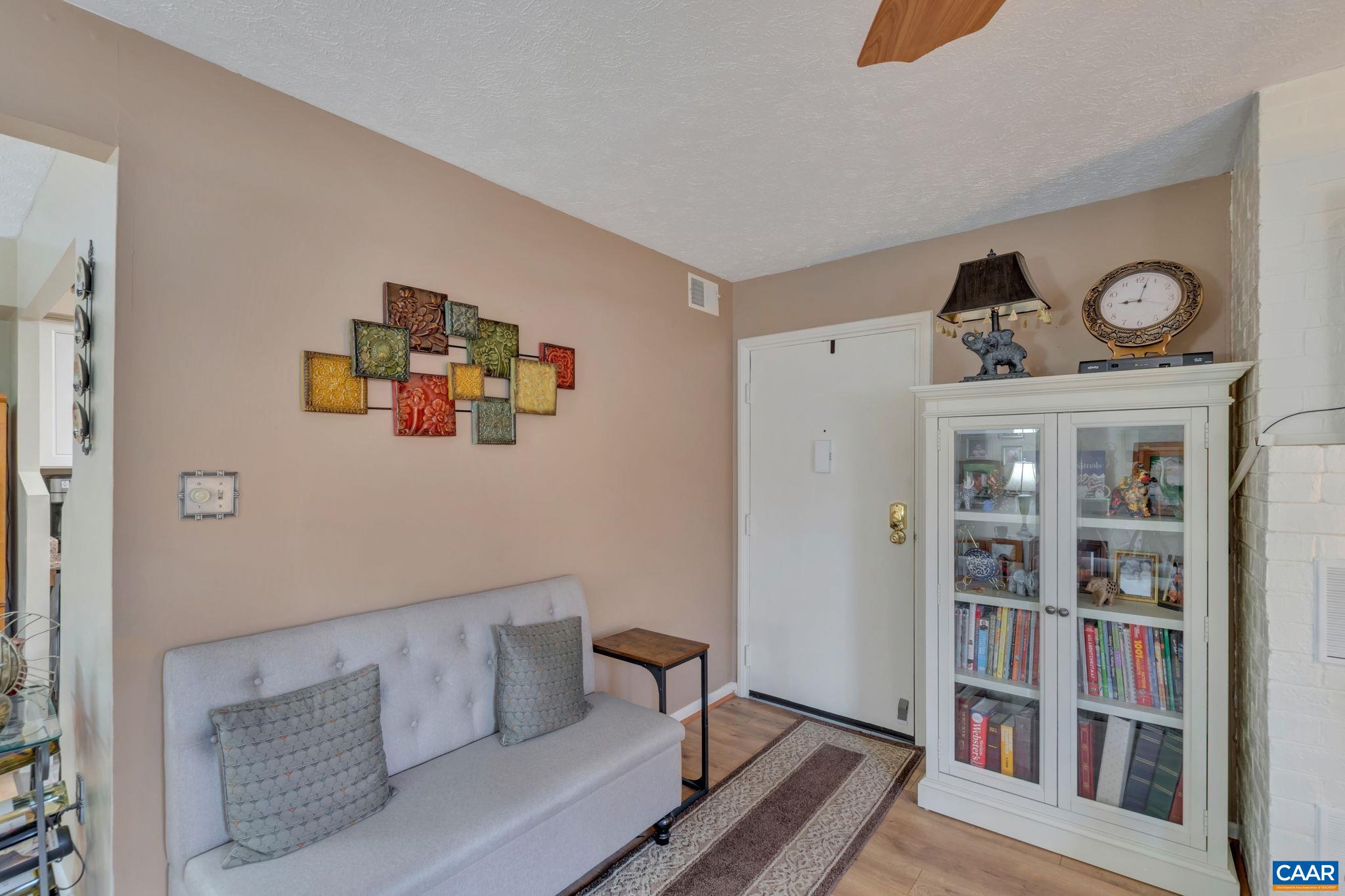 114 Turtle Creek Road, Unit 1 Charlottesville, VA 22901 - Photo 5 of 24 a living room with furniture and a book shelf