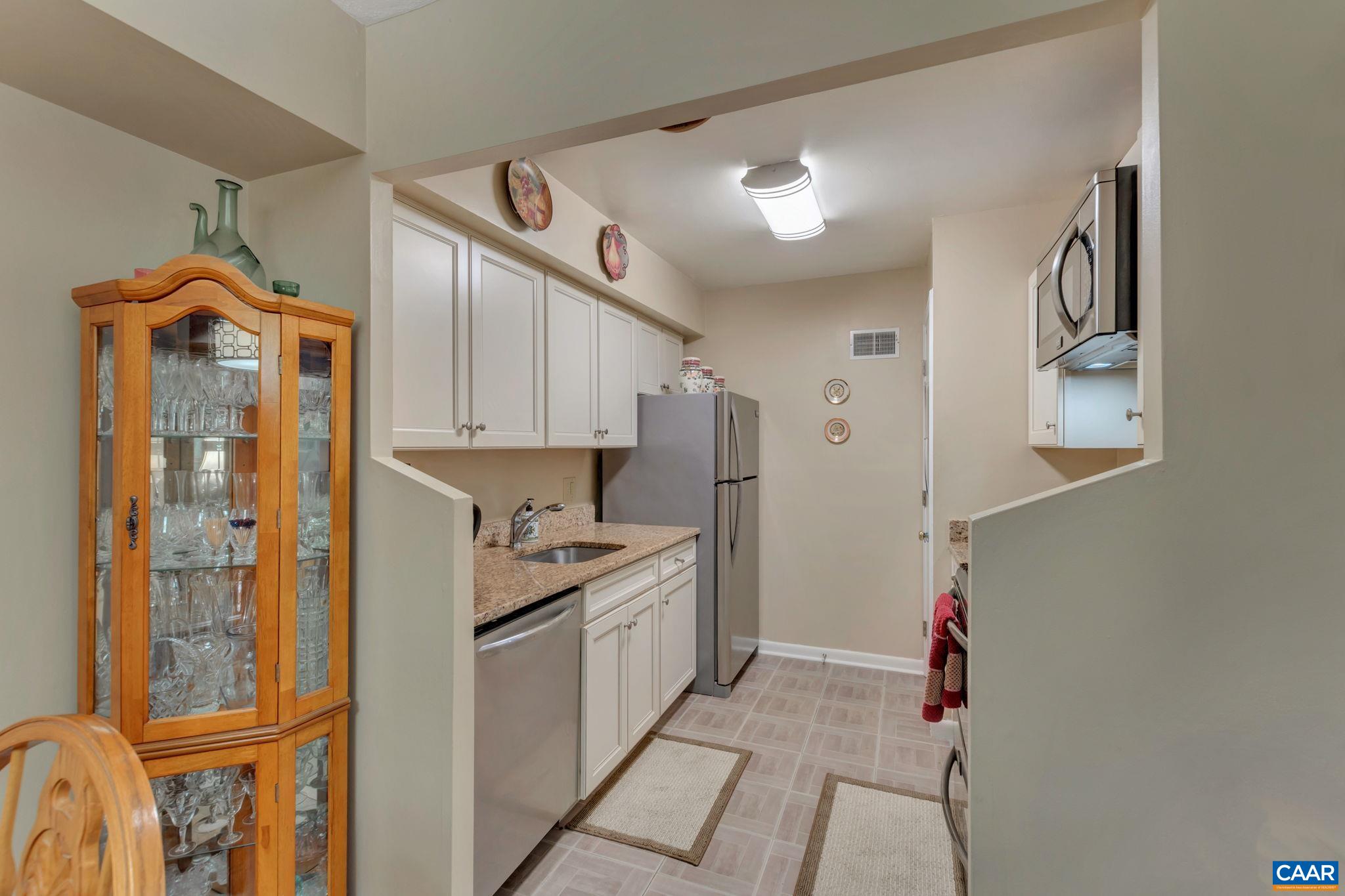 114 Turtle Creek Road, Unit 1 Charlottesville, VA 22901 - Photo 7 of 24 a kitchen with a refrigerator a sink and cabinets