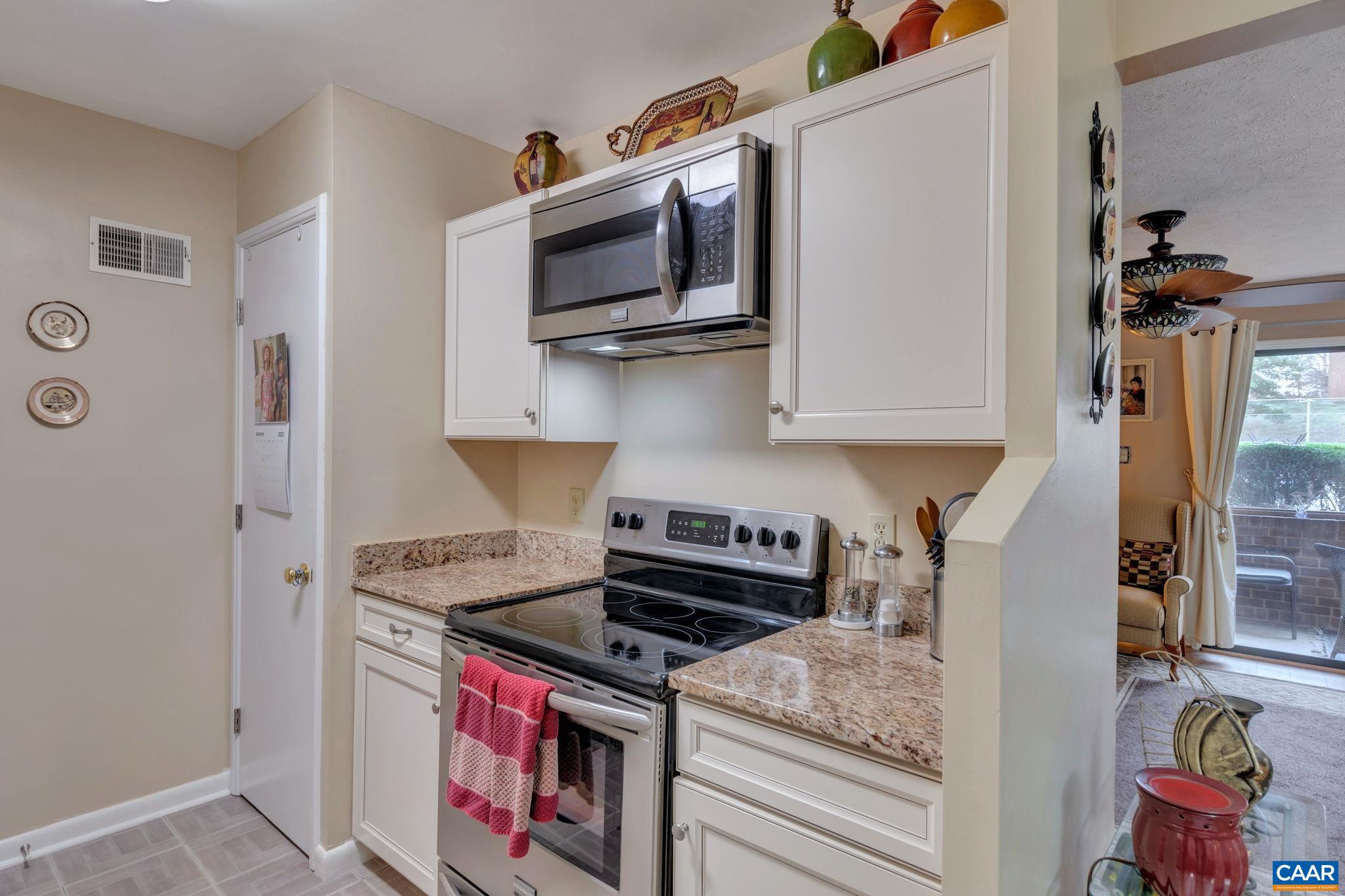 114 Turtle Creek Road, Unit 1 Charlottesville, VA 22901 - Photo 10 of 24 a kitchen with stainless steel appliances granite countertop a stove and a microwave