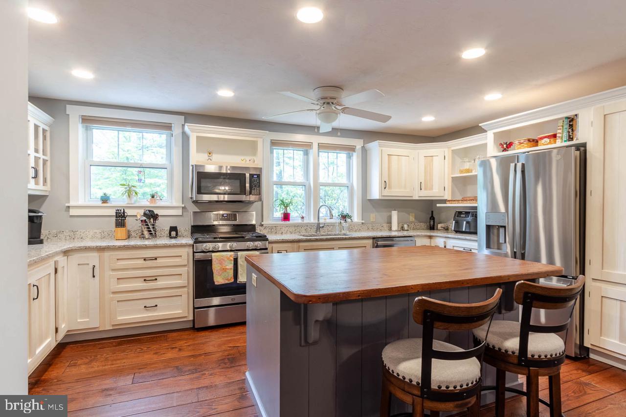 1834 Decker Hollow Road Tyrone, PA 16686 - Photo 17 of 40 a kitchen with stainless steel appliances granite countertop a stove a sink and a refrigerator