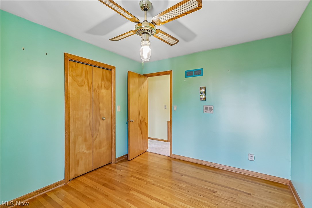 2060 6th Street Southwest Akron, OH 44314 - Photo 22 of 46 Bedroom with ceiling light / fan, closet and wood flooring