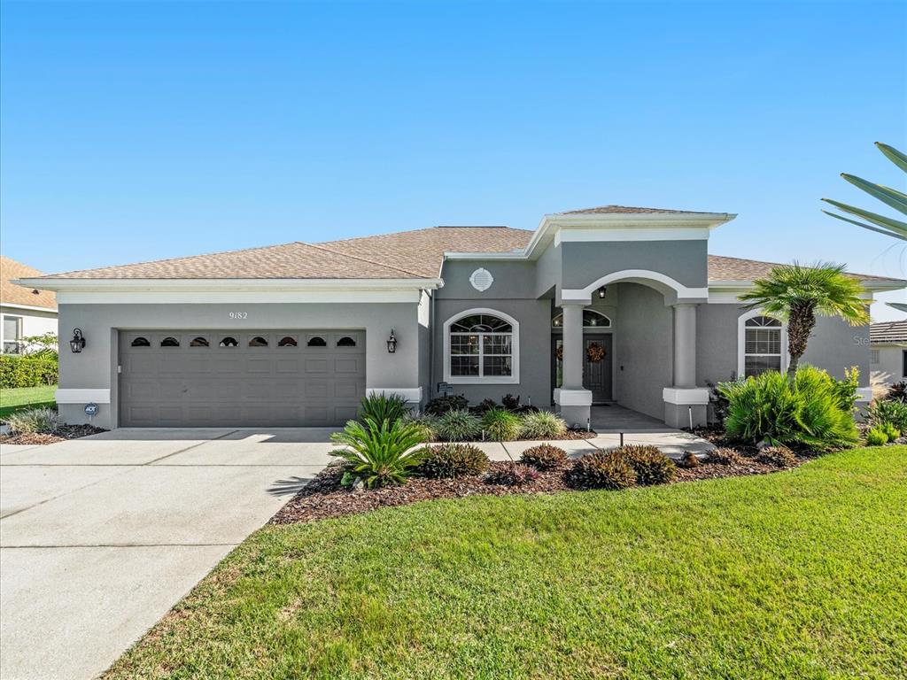 9182 Tarleton Circle Weeki Wachee, FL 34613 - Photo 1 of 23 a front view of a house with a garden