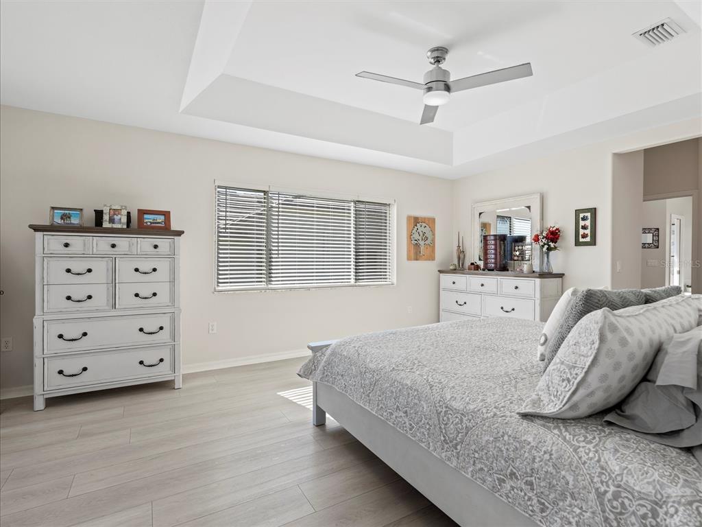 9182 Tarleton Circle Weeki Wachee, FL 34613 - Photo 11 of 23 a bedroom with a bed a dresser and a window