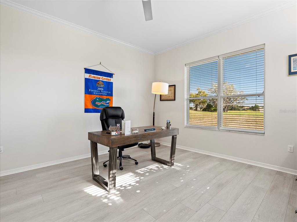 9182 Tarleton Circle Weeki Wachee, FL 34613 - Photo 14 of 23 a view of a workspace with furniture and a window