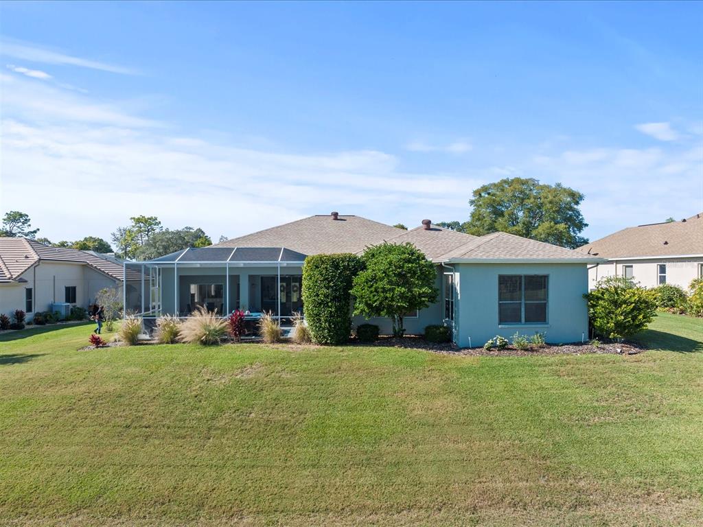 9182 Tarleton Circle Weeki Wachee, FL 34613 - Photo 22 of 23 a front view of a house with a yard porch and outdoor seating