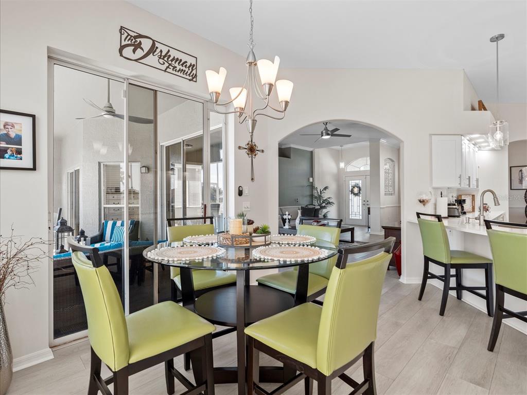 9182 Tarleton Circle Weeki Wachee, FL 34613 - Photo 5 of 23 a view of a a dining room with furniture window and wooden floor
