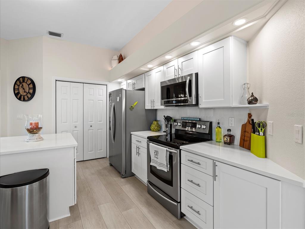 9182 Tarleton Circle Weeki Wachee, FL 34613 - Photo 8 of 23 a kitchen with a sink a stove and refrigerator
