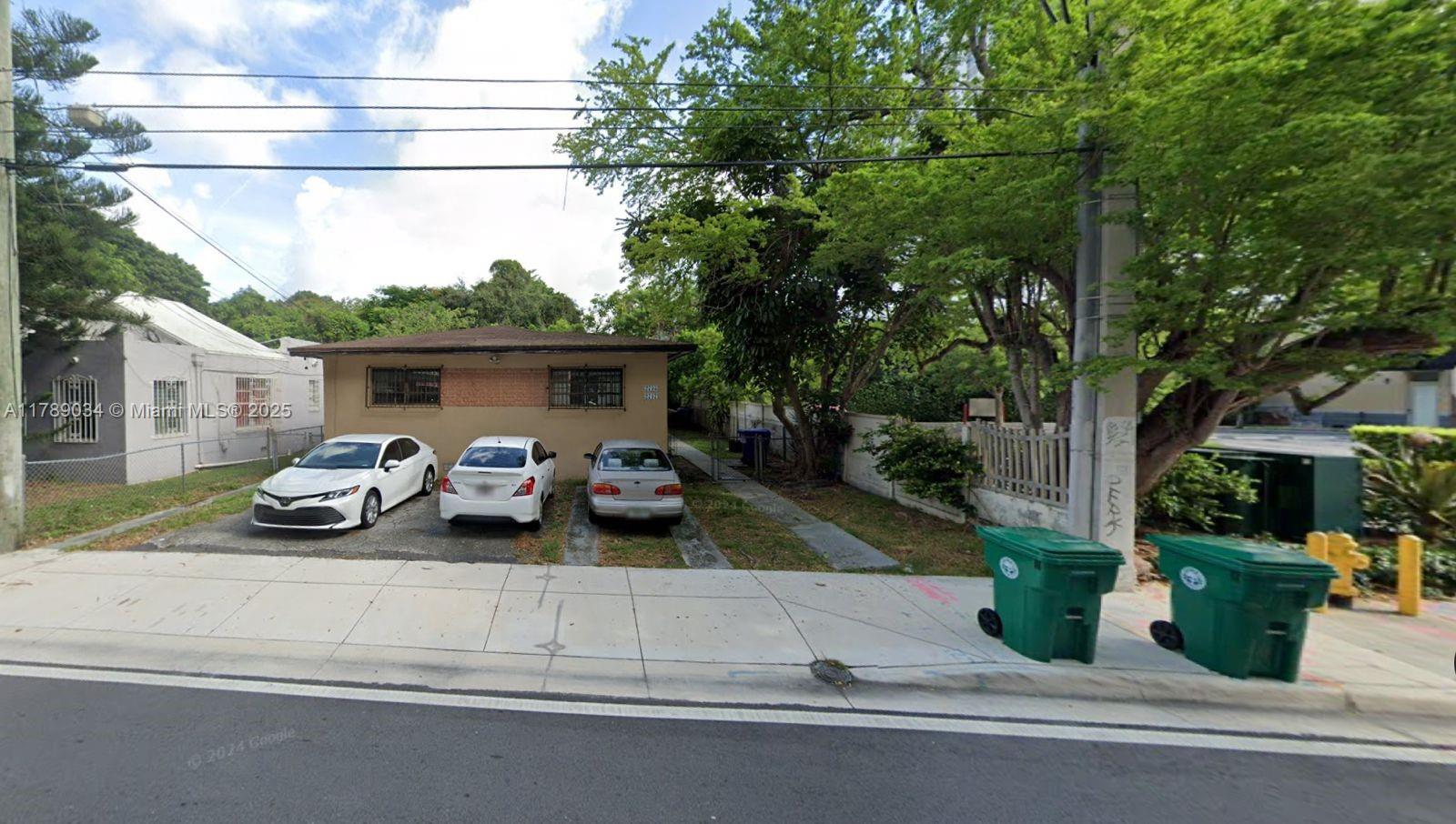 2735 Southwest 27th Terrace Miami, FL 33133 - Photo 2 of 3 a view of a house with a patio door and a fire pit