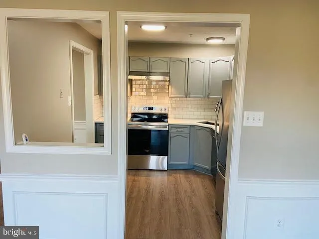a kitchen with stainless steel appliances granite countertop a sink and a stove top oven