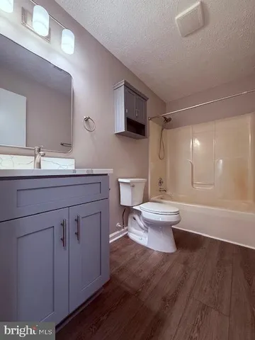 a bathroom with a double vanity sink mirror and toilet