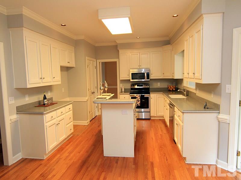 7023 Spring Ridge Road Cary, NC 27518 - Photo 4 of 12 Plenty of cabinets, a large pantry and desk area make up this clean and functional kitchen. New appliances!