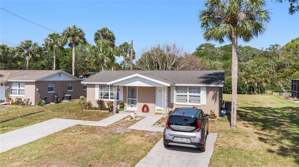 8304 Old Post Road Port Richey, FL 34668 - Photo 1 of 1 a front view of a house with garden