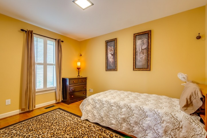 7357 Overby Road Fairview, TN 37062 - Photo 14 of 15 a bedroom with a bed and wooden floor