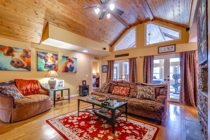 7357 Overby Road Fairview, TN 37062 - Photo 6 of 15 a living room with furniture a rug and a chandelier