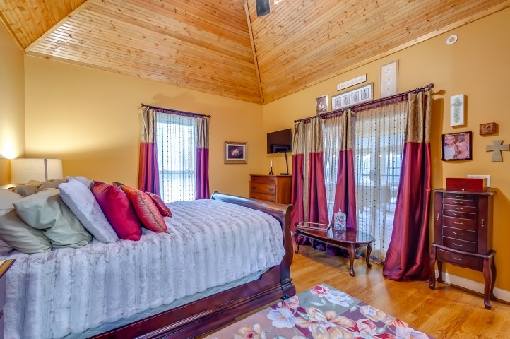 7357 Overby Road Fairview, TN 37062 - Photo 7 of 15 a bedroom with a bed and a chandelier