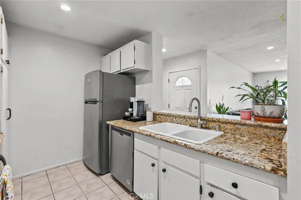 a bathroom with a granite countertop sink a mirror and a shower