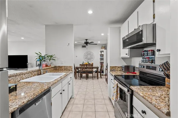 a kitchen with granite countertop lots of counter top space and stainless steel appliances