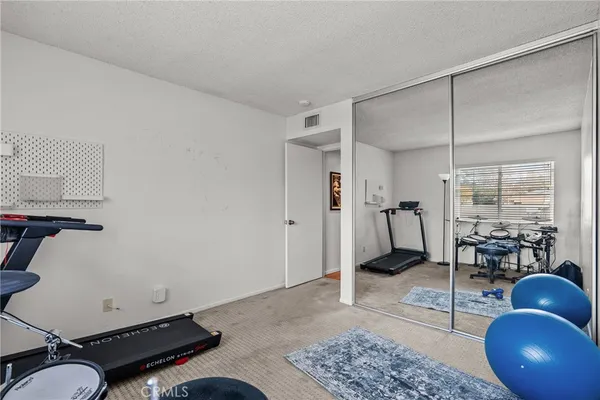 a room with gym equipment and a window
