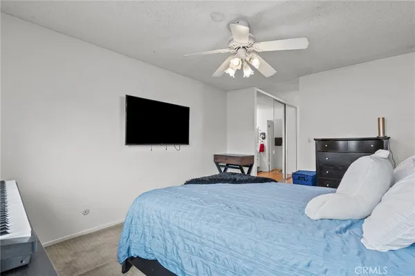 a bedroom with furniture and a flat screen tv