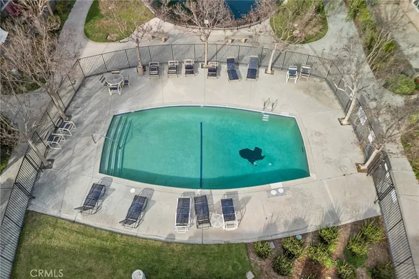 a swimming pool with outdoor seating and yard