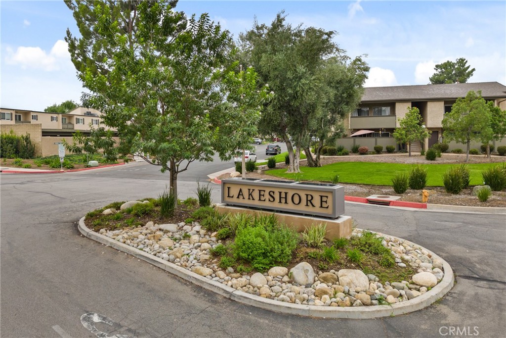 25736 Player Drive, Unit R4 Valencia, CA 91355 - Photo 5 of 50 a sign that is sitting in front of a house with a tree