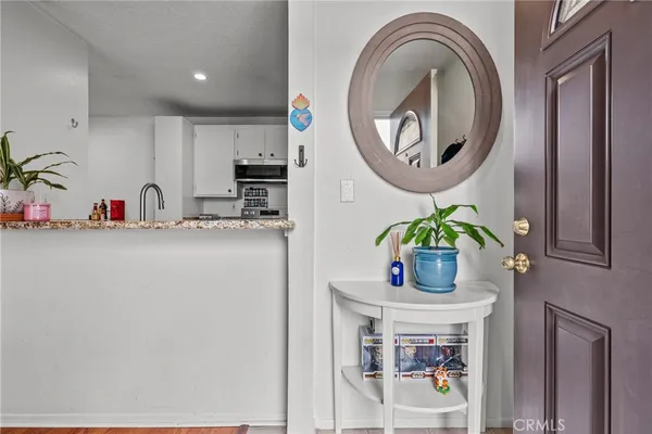 a kitchen with stainless steel appliances granite countertop a white cabinets and a sink