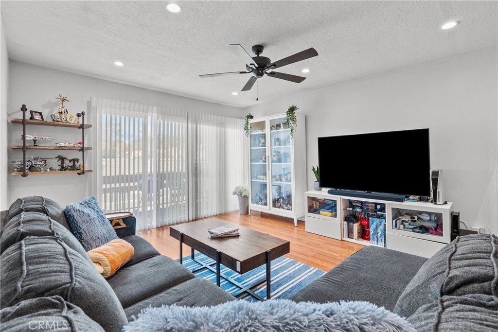 25736 Player Drive, Unit R4 Valencia, CA 91355 - Photo 10 of 50 a living room with furniture and a flat screen tv