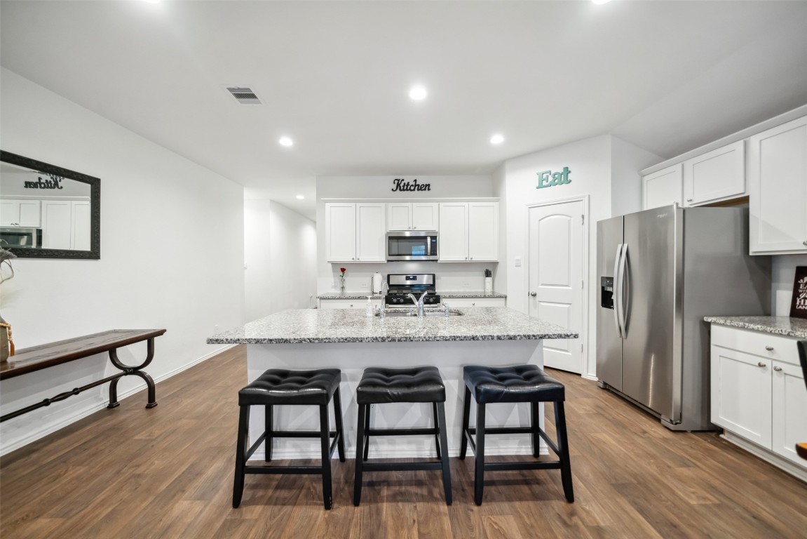 3308 Cold Swan Court Conroe, TX 77301 - Photo 12 of 25 Enjoy the counter height breakfast bar with 3 bar stools.
