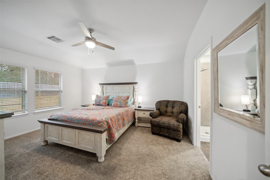 3308 Cold Swan Court Conroe, TX 77301 - Photo 18 of 25 Entry into the primary bedroom is furnished with a queen bedroom set and sitting chair.