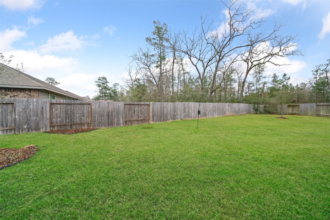 3308 Cold Swan Court Conroe, TX 77301 - Photo 24 of 25 Huge backyard is fully fenced and backs up to woods.