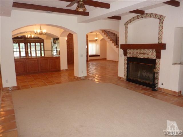 51 Buckskin Road Bell Canyon, CA 91307 - Photo 4 of 24 an empty room with windows a fireplace and a chandelier