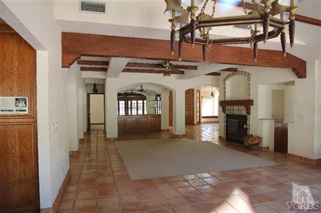 51 Buckskin Road Bell Canyon, CA 91307 - Photo 10 of 24 a view of a hallway with wooden floor and a fireplace