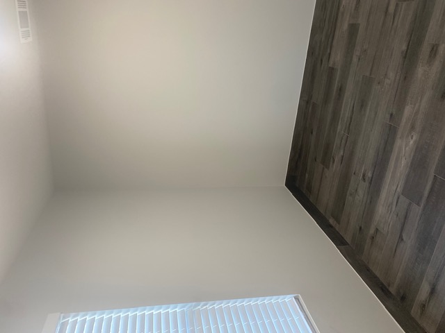 183 Mimosa Road Dale, TX 78616 - Photo 9 of 11 Wood-finish flooring with white baseboards and light-toned walls