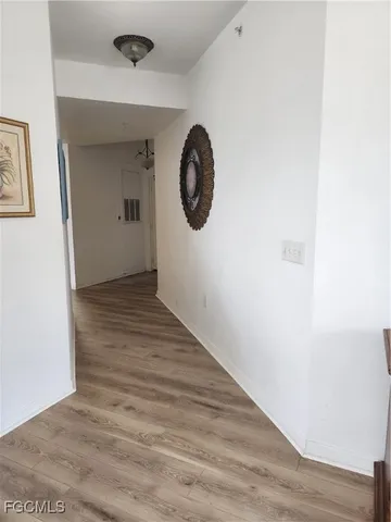 a view of a hallway with wooden floor