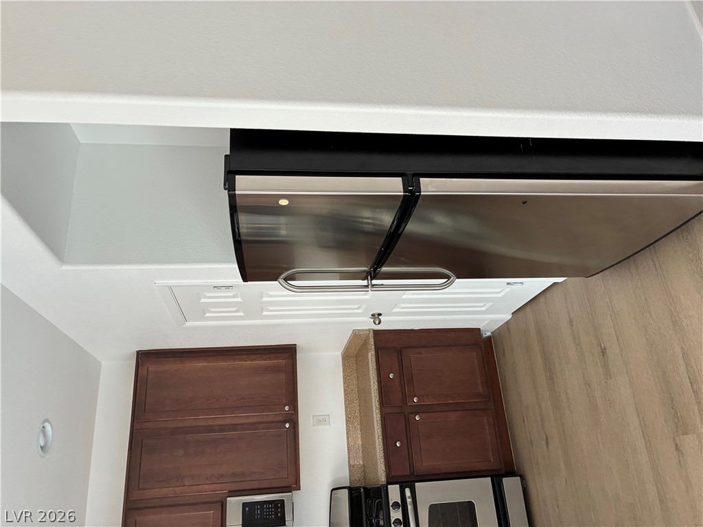 7727 Pista Way Las Vegas, NV 89179 - Photo 4 of 12 Stainless steel appliances complement rich cabinetry in this inviting kitchen space.