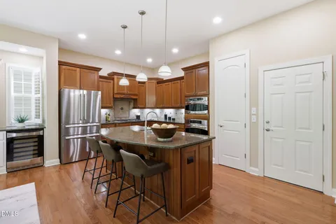 a kitchen with kitchen island granite countertop lots of counter top space and stainless steel appliances