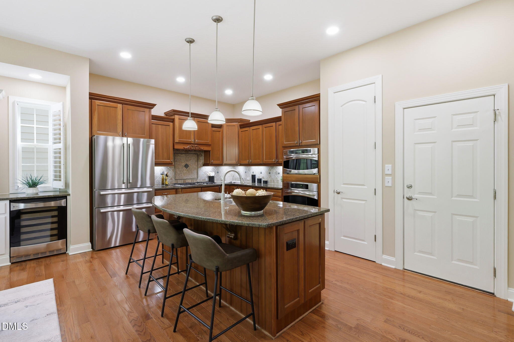 804 Long Meadows Road Chapel Hill, NC 27516 - Photo 12 of 50 a kitchen with stainless steel appliances a table chairs refrigerator and microwave