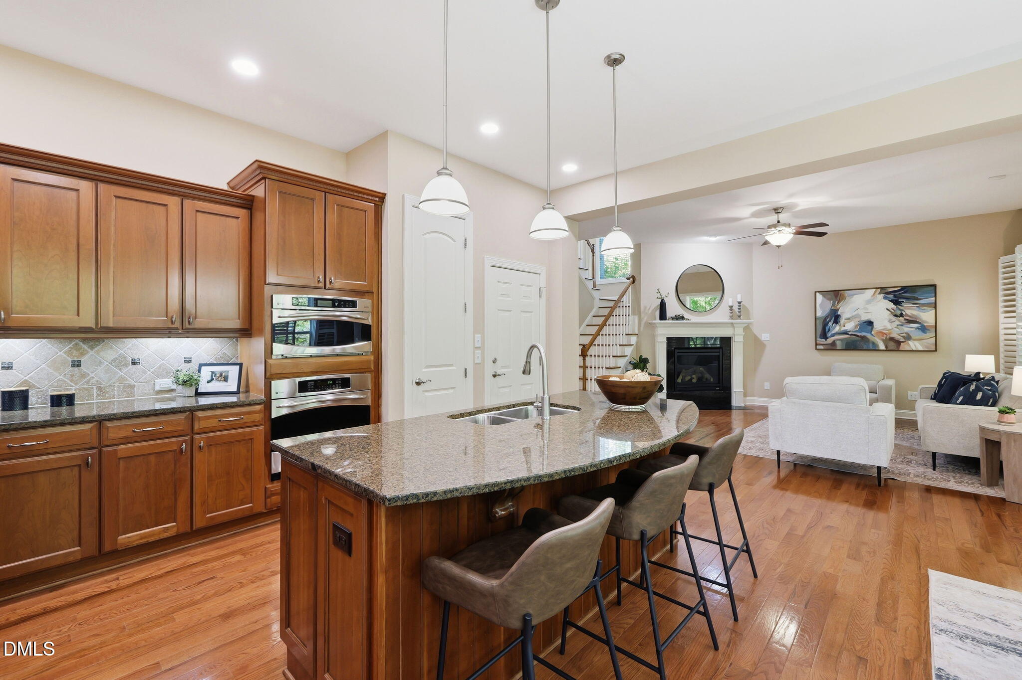 804 Long Meadows Road Chapel Hill, NC 27516 - Photo 15 of 50 a kitchen with granite countertop a stove a sink dishwasher a dining table and chairs with wooden floor