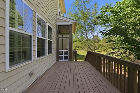 a balcony with furniture and wooden floor
