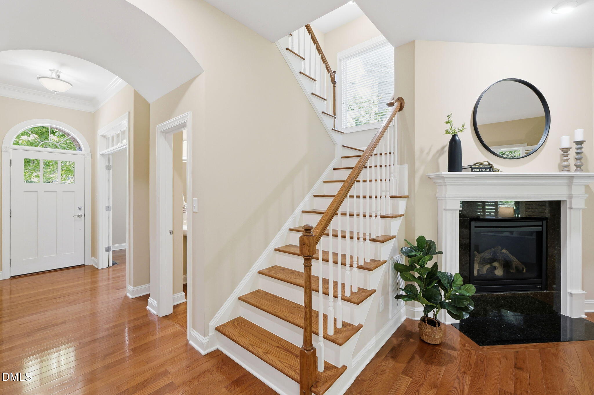 804 Long Meadows Road Chapel Hill, NC 27516 - Photo 22 of 50 a view of an entryway with wooden floor a fireplace and a chandelier